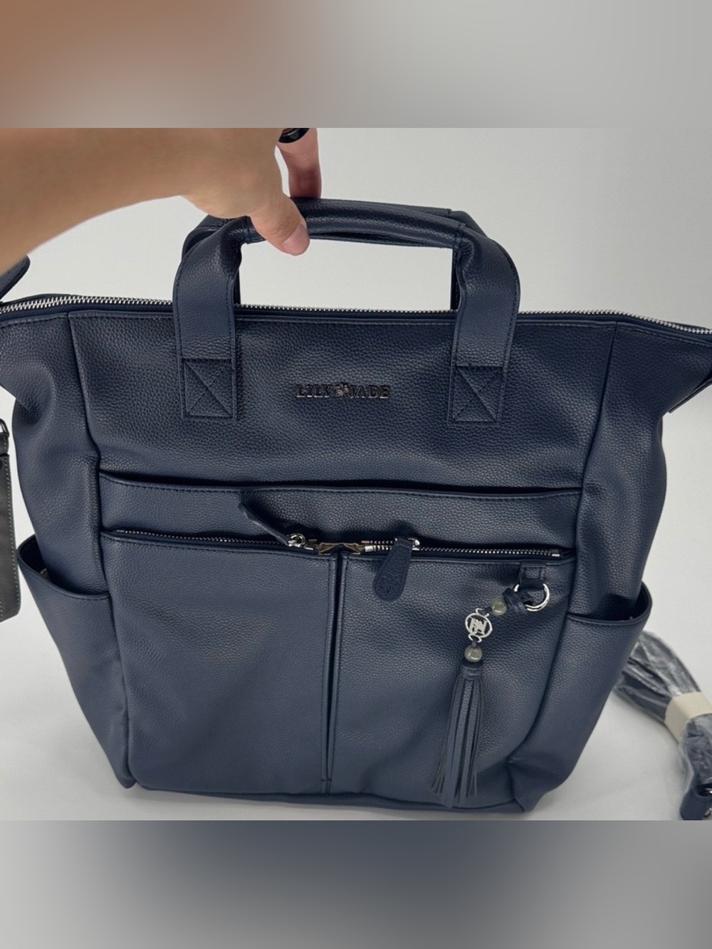 Like new Lily Jade faux leather convertible Dark Blue Backpack with Tassel